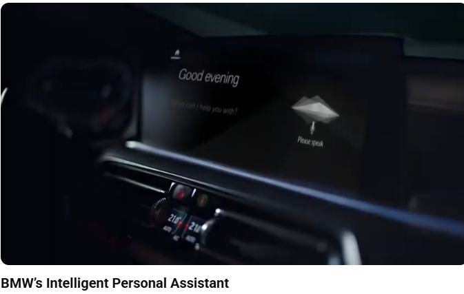 Dark BMW Dashboard interior screen display, showing the Assistant saying "Good Evening" from the 'BMW’s Intelligent Personal Assistant' WM Cline Commercial Voiceover Video