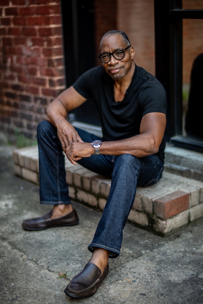 William Marshall Cline Voice Actor and Narrator, seated in black t-shirt and jeans