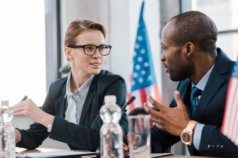 2 Professional Colleagues talking through their agenda for a political meeting.